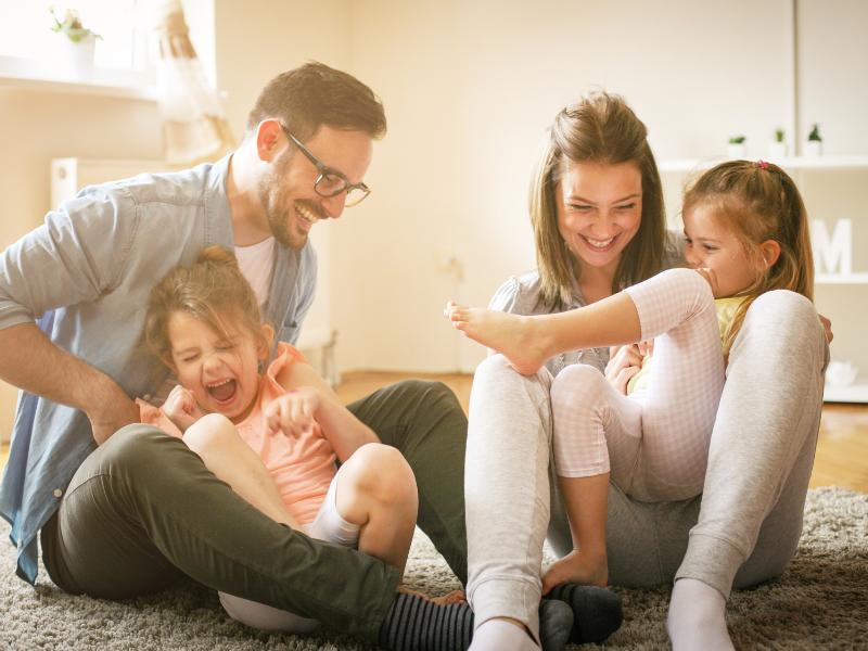 family running through a field living pain free